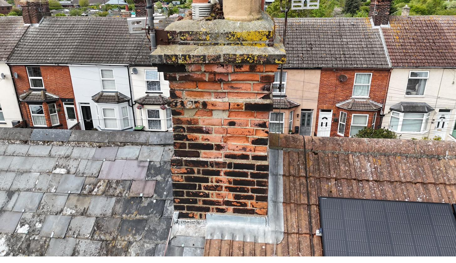 Defective brickwork and pointing on a chimney stack
